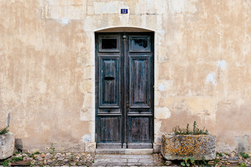 Old wooden closed door with number 12