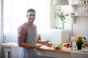Businessman feeling satisfied after cooking at home