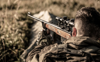 The man is on the hunt. Hunt hunting rifle. Hunter man. Hunter with hunting gun and hunting form to...