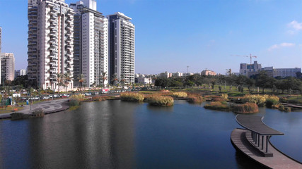 Drone Image over Lake Palm Trees And Modern Buildings aerial View, Israel