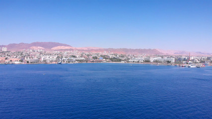 Eilat City Skyilne with Hotels boats and desert aerial