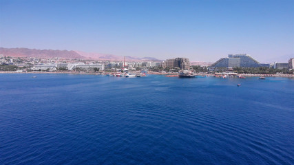 Fototapeta na wymiar Drone Image over Eilat shoreline With Marina boats And hotels in the summer