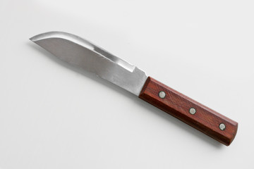 Kitchen utensils - a wide meat knife with a wooden handle on a light background. Cooking tools.