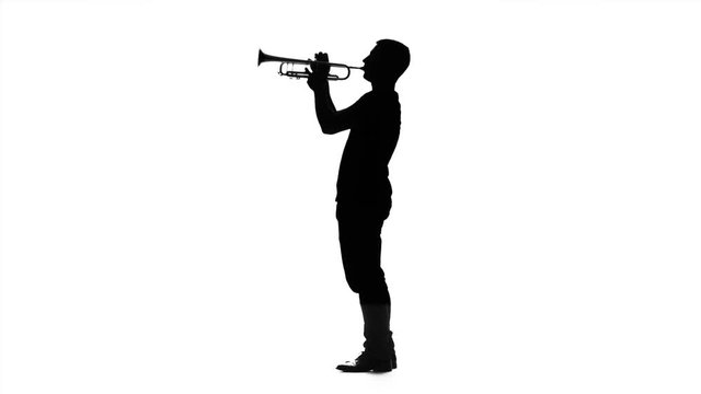 Musician professional playing on trumpet in slow motion. Black silhouette