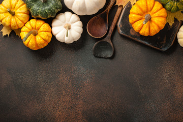 Happy Thanksgiving background with decorative pumpkins and vintage wooden spoons