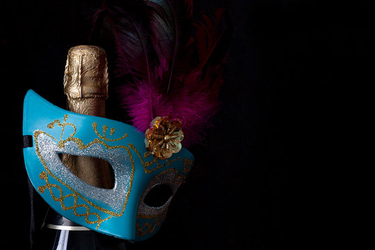 CARNIVAL MASK AND BOTTLE OF CHAMPAGNE. CARNIVAL PARTY TIME IN FEBRUARY.