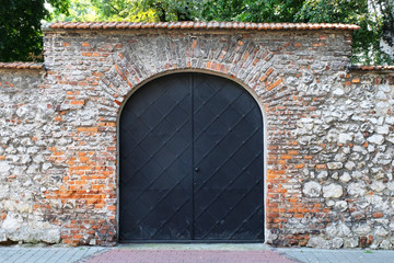 old door, gate brick wall. Entrance to the castle