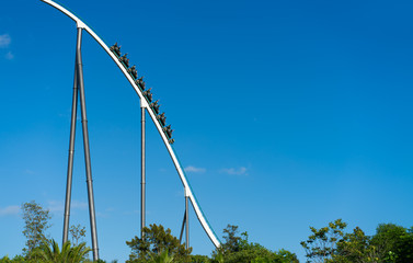 Roller coaster with train full of people in theme park