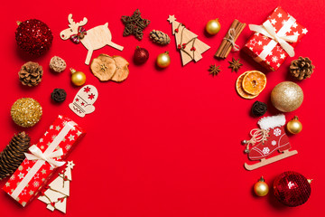 Top view of Christmas decorations on red background. New Year holiday concept with copy space