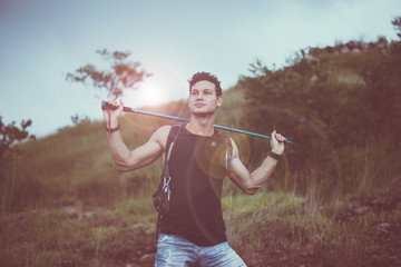 Handsome male holding trekking pole and looking something at nature,Happy and smiling,Travel at outdoor