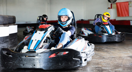 Group of people driving go-carts at racing track