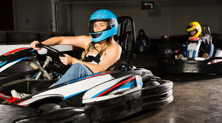 Fototapeta na wymiar Female driving go-kart car indoor