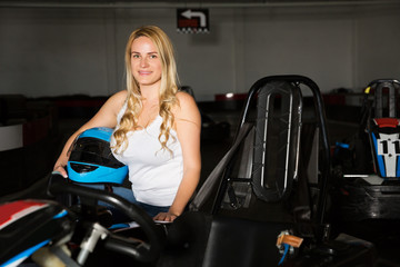 Fototapeta na wymiar woman with helmet sitting in car for motor racing