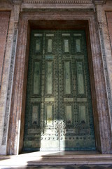 Ancient roman bronze door from Roman Senate (Curia Julia) still in use. Archbasilica of Saint John Lateran facade. Rome, Italy.