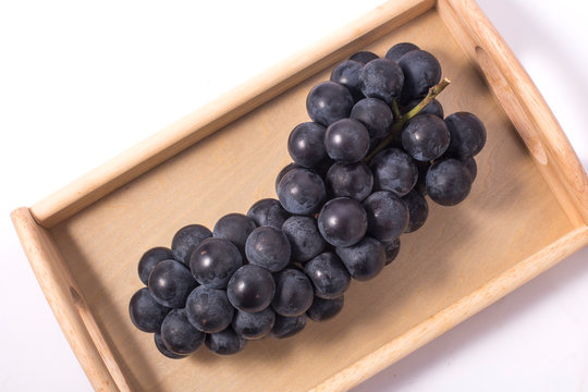 Tray With Ripe Sweet Grapes On White Background