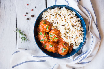 Meatballs with rice and tomato sauce in a bowl
