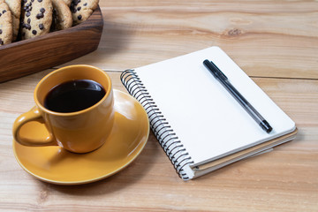 cup of coffee on wooden background cookies plan day notebook morning business diary aroma