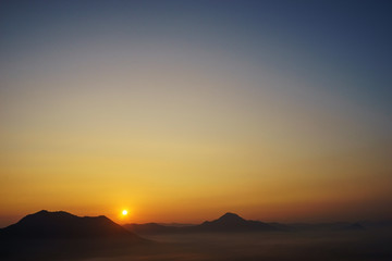 sunrise and fog in the mountains background