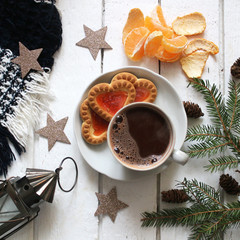 Christmas still life on a white wooden background top view. Fir branches, lantern, shining stars are arranged in a circle. Free space for an inscription. The concept of winter holidays, new year card,