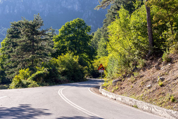 Narrow mountain road and  sign 