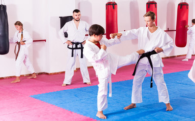 Children working in pair mastering new karate moves