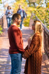 Couple in love holding hands in the park in Autumn