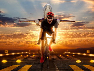 Man racing cyclist on runway