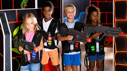 Group of cheerful tweenagers with laser guns