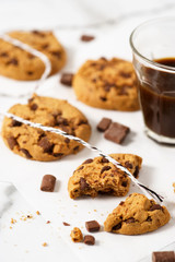Cookies with dark chocolate chips on white plate.