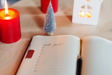 New Year's goals with christmas decorations and candles.