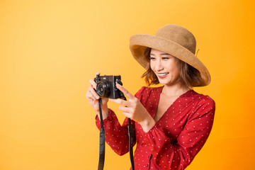 Portrait of fashionable young woman with vintage film camera for travelling concept. Isolated on...