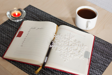 New Year's goals with christmas decorations and candles.