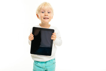 smiling charming boy with a tablet in hand screen forward on a white isolated background
