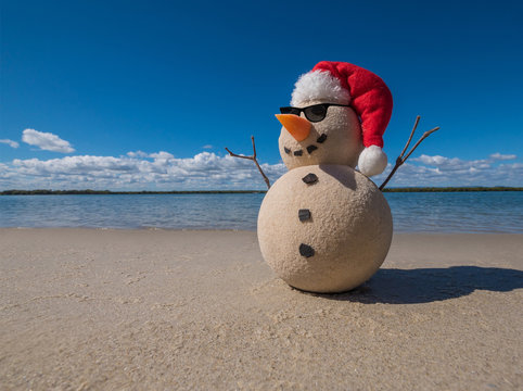 Christmas Sandy Snowman on a beautiful sand beach - Christmas symbol of countries where the weather is always warm