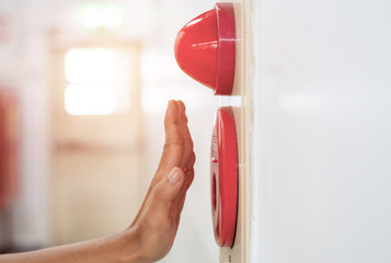 Hand above a red emergency button