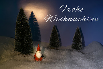 Little Santa Claus in the snow, card with the German words for merry Christmas