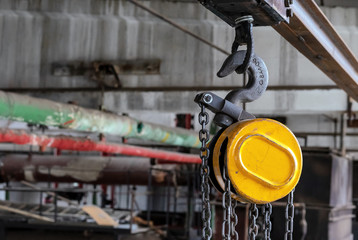 Hook on a beam crane for lifting and moving cargo in production rooms.