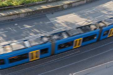 Fototapeta premium View from the top of a street with a fast passing tram