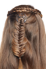 Extreme close-up shot of female hair-do made as a classic braid crown and a spikelet braid fixed...