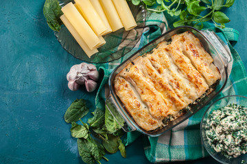Cannelloni pasta stuffed with spinach and ricotta - 299287680