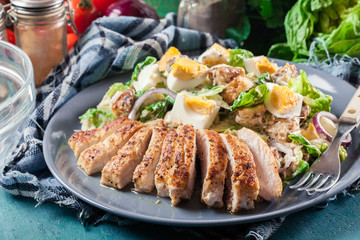 Healthy caesar salad with chicken, eggs and croutons