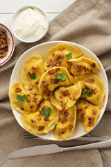 Yellow dumplings with turmeric, fried onions and parsley