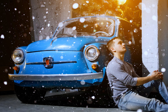 Man Sits Near Retro Car At Christmas