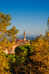 Naklejka premium Autumn in Perugia. View of the beautiful Perugia medieval historic center and Umbria countryside with the iconic St Peter hexagonal belltower and autumnal leaves