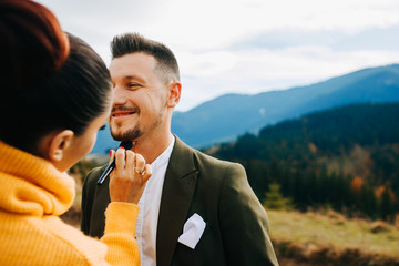 Girl makes makeup for her husband
