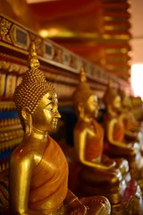 Golden statue of buddha in temple, Thailand