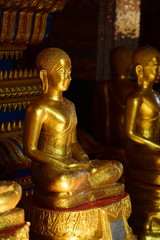 Golden statue of buddha in temple, Thailand	