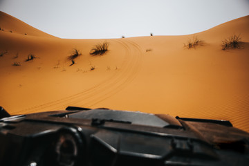 Beautiful view of desert dune from a rally buggy cockpit during rally adventure.