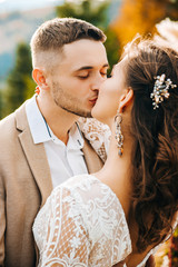 Amazing moment of the wedding ceremony. The groom kisses his wife.