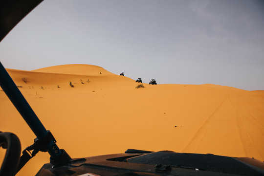 Off Road Buggies Crossing Dunes In The Desert. Rally Raid Adventure.